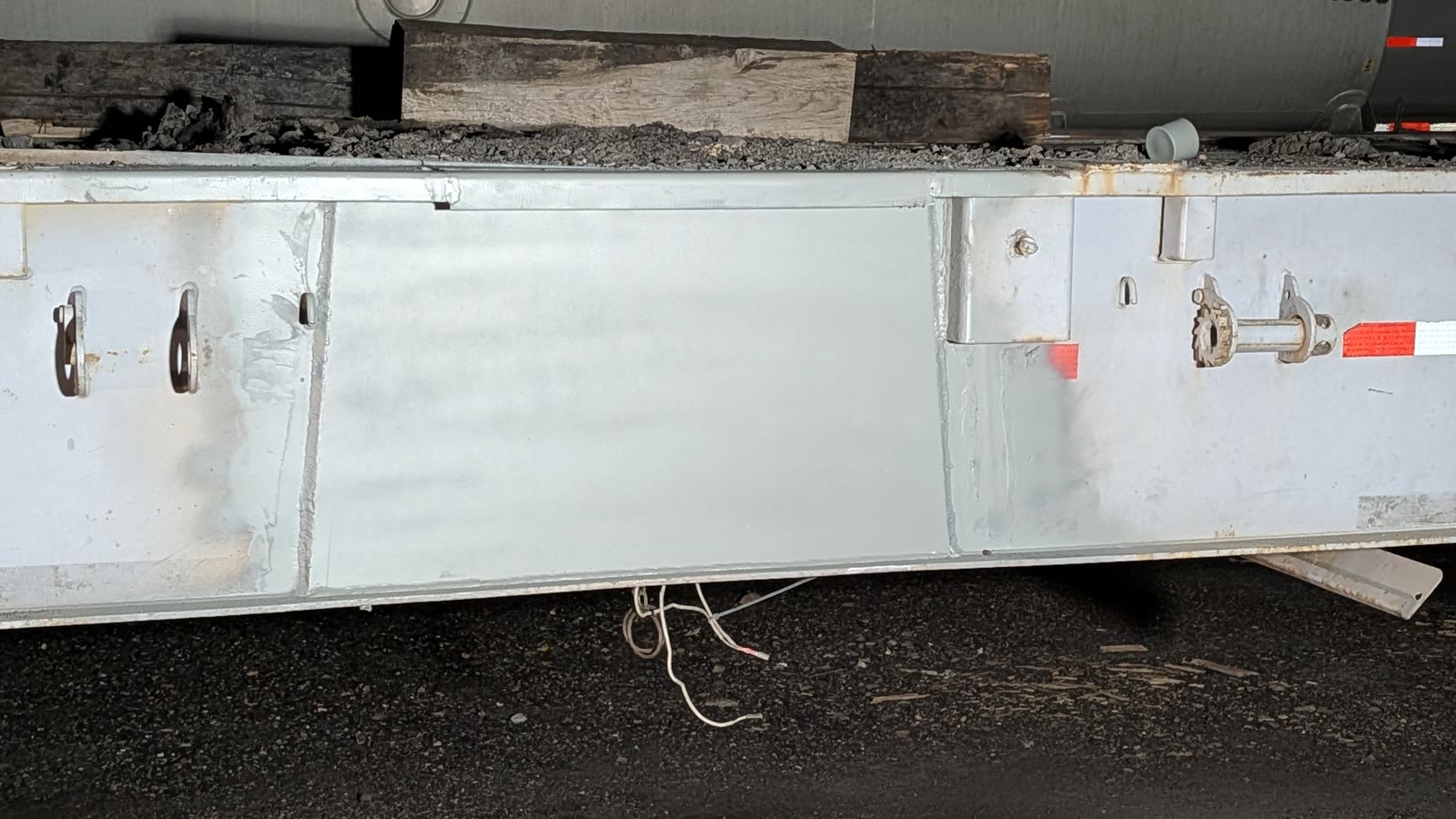 Repaired and repainted side panel of a commercial trailer.